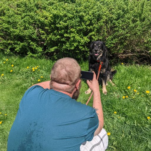 man taking picture of dog outside | Work With Us