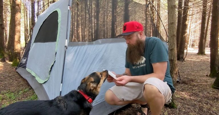 man holding gear repair tape next to a tent | Get Ready for Camping Like a Pro