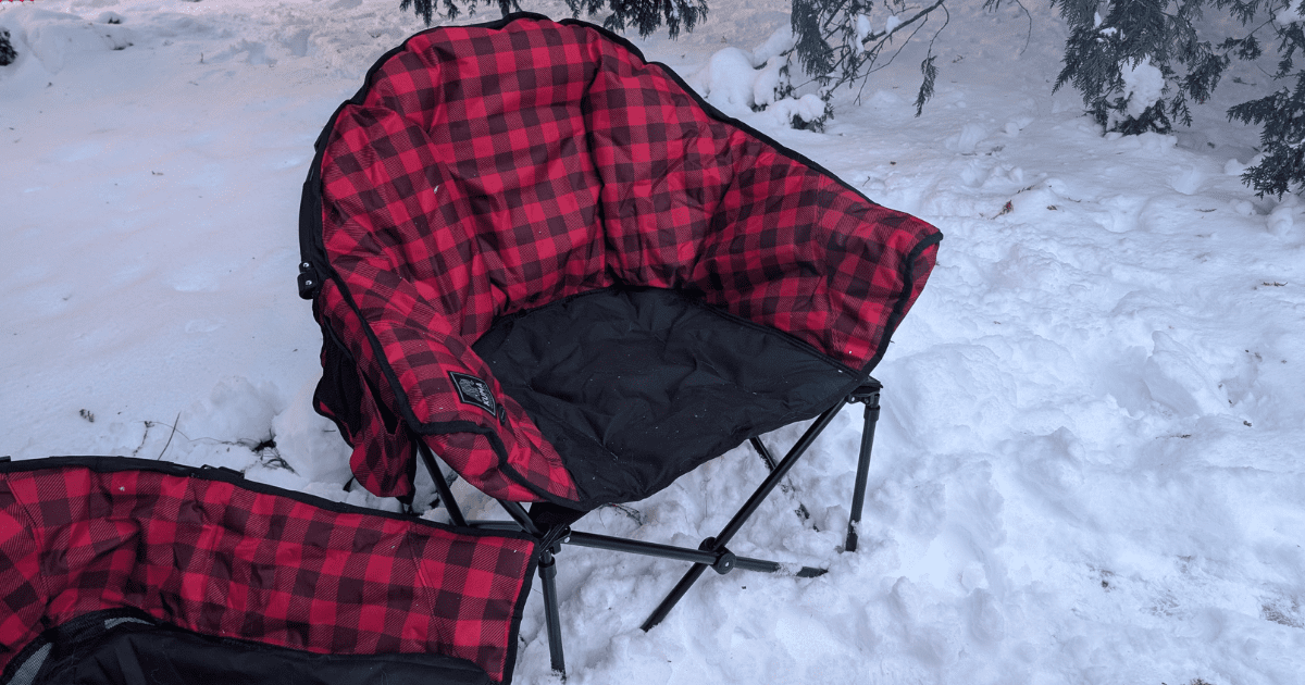 two red and black camp chairs sitting outside in the snow | Unwind Anywhere: Our Honest Review of KUMA's Lazy Bear Heated Chair & Cozy Dog Bed
